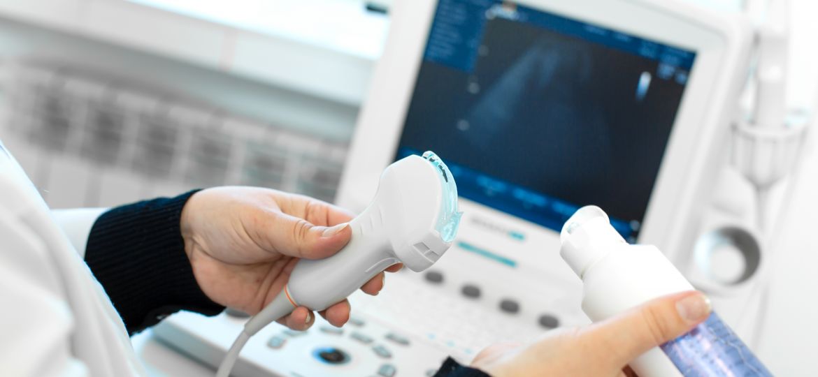 Doctor prepare an ultrasound machine for the diagnosis of a patient. Doctor puts media gel on an ultrasound transducer